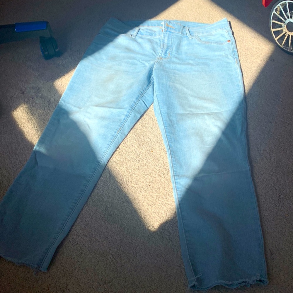 Light wash Old Navy frayed “super skinny mid-rise” jeans.